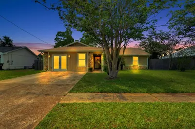 a house with a tree in the front yard at Luxe Guest Suite Near The Emerald Coast of PCB in Panama City