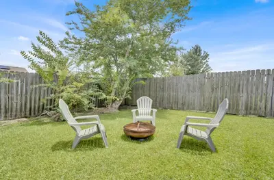 three chairs and a fire pit in a yard at Luxe Guest Suite Near The Emerald Coast of PCB in Panama City