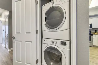 a washer and dryer in a room with a door at Shores of Panama 1426 condo in Panama City Beach