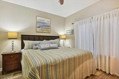 a bedroom with a large bed and a window at Shores of Panama 1708 condo in Panama City Beach