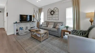 a living room with a couch and a fireplace at KK's Beach House - Newly remodeled, close to Seaside, easy walk to beach in Santa Rosa Beach