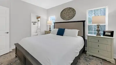 a white bedroom with a large bed and a window at KK's Beach House - Newly remodeled, close to Seaside, easy walk to beach in Santa Rosa Beach