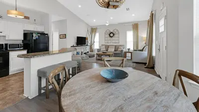 a kitchen and living room with a table and chairs at KK's Beach House - Newly remodeled, close to Seaside, easy walk to beach in Santa Rosa Beach