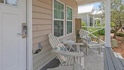 a pair of chairs sitting on a porch at KK's Beach House - Newly remodeled, close to Seaside, easy walk to beach in Santa Rosa Beach