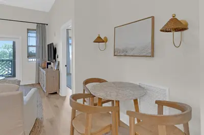 a dining room with a table and two chairs at Emerald By Alma - Updated 3BD 2BA condo Seagrove Highlands in Santa Rosa Beach