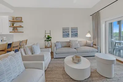a living room with white furniture and a table at Emerald By Alma - Updated 3BD 2BA condo Seagrove Highlands in Santa Rosa Beach