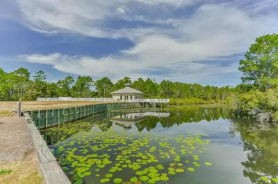 a bridge over a lake with a gazebo at Emerald By Alma - Updated 3BD 2BA condo Seagrove Highlands in Santa Rosa Beach