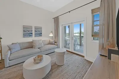 a living room with a couch and a table at Emerald By Alma - Updated 3BD 2BA condo Seagrove Highlands in Santa Rosa Beach