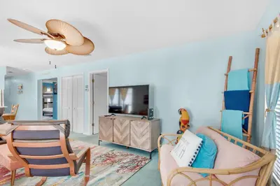 a living room with a couch and a table at Seashells at the Beach Retreat in Panama City Beach