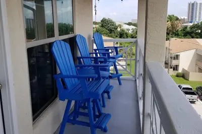 three blue chairs sitting on a balcony at Gulf Views from your 2 private balconies! in Panama City Beach