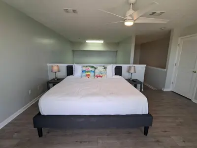 a bedroom with a large white bed with two lamps at Gulf Views from your 2 private balconies! in Panama City Beach