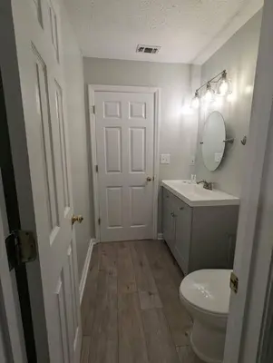 a bathroom with a toilet and a sink and a mirror at Gulf Views from your 2 private balconies! in Panama City Beach