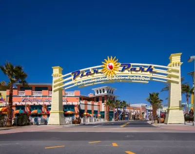 a large sign for a resort with a sun sign at Gulf Views from your 2 private balconies! in Panama City Beach