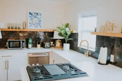 a kitchen with a counter with a stove top at Dream On – Style & Comfort Near Historic Downtown in Panama City