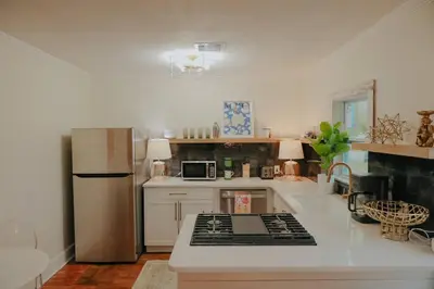 a kitchen with a refrigerator and a stove top oven at Dream On – Style & Comfort Near Historic Downtown in Panama City