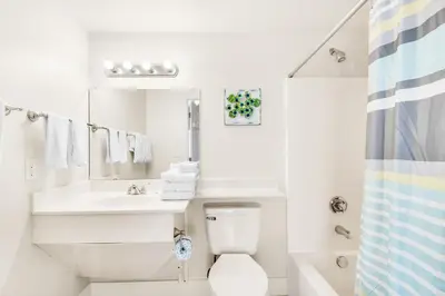 a white bathroom with a sink and a toilet at Shores of Panama 2122 in Panama City Beach