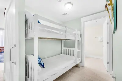 a white bunk bed in a white room at Shores of Panama 2122 in Panama City Beach