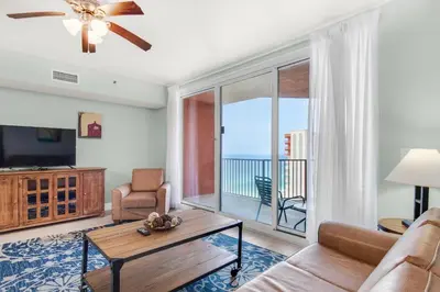 a living room with a couch and a flat screen tv at Shores of Panama 2122 in Panama City Beach