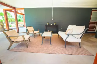 a living room with two chairs and a couch and a table at Conch Cottage in Panama City Beach