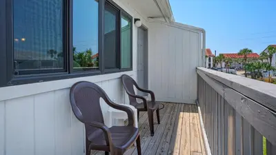 two chairs sitting on the balcony of a house at Hidden Beach 235 in Santa Rosa Beach