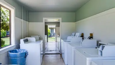 a row of white washing machines in a room at Hidden Beach 235 in Santa Rosa Beach