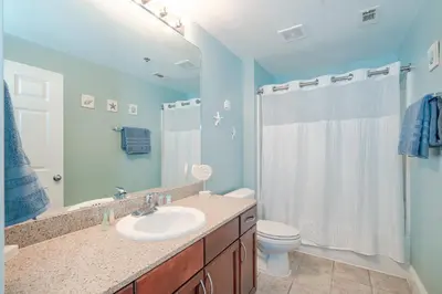 a bathroom with a sink and a toilet and a shower at Laketown Wharf #119 by Nautical Properties in Panama City Beach