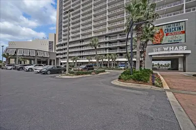 a parking lot in front of a large building at Laketown Wharf #119 by Nautical Properties in Panama City Beach