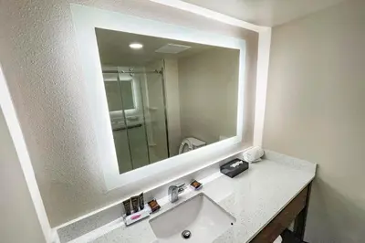 a bathroom with a sink and a large mirror at Wingate by Wyndham Panama City Area Lynn Haven in Panama City
