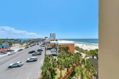 a view of a beach with cars parked on the road at Aqua Resort 401 - Piece of Serenity in Panama City Beach