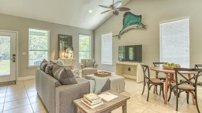 a living room with a couch and a table at Flip Flop Cottage - Great rates and dog friendly with additional pet fee in Santa Rosa Beach