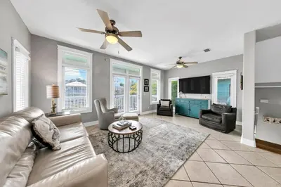 a living room with a couch and a ceiling fan at Seashine and Sunkises - Great pricing near Seaside in Santa Rosa Beach