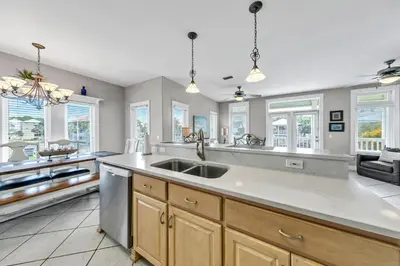 a large kitchen with a sink and windows at Seashine and Sunkises - Great pricing near Seaside in Santa Rosa Beach