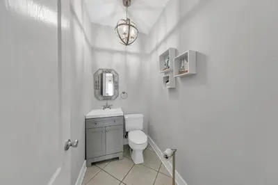 a bathroom with a toilet and a sink and a mirror at Seashine and Sunkises - Great pricing near Seaside in Santa Rosa Beach