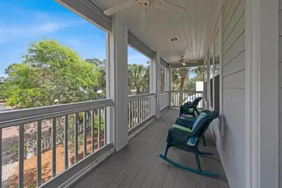 a porch with two chairs and a view of the ocean at Memory Maker II - Modern Home with 4Bedrooms and 3 and a half baths in Seagrove Beach along 30a in Santa Rosa Beach