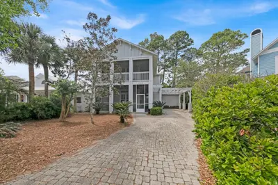 an exterior view of a white house with a driveway at Memory Maker II - Modern Home with 4Bedrooms and 3 and a half baths in Seagrove Beach along 30a in Santa Rosa Beach