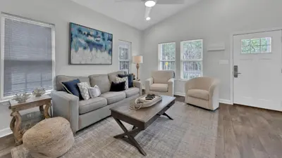 a living room with a couch and two chairs and a table at Luna Sea - Is a short walk to the beach and close to Seaside in Santa Rosa Beach