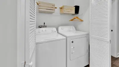 a white laundry room with two washer and dryer at Luna Sea - Is a short walk to the beach and close to Seaside in Santa Rosa Beach
