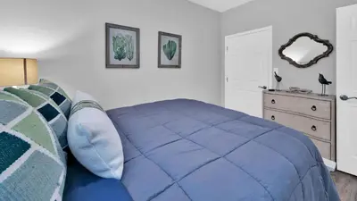 a bedroom with a blue bed and a dresser at Luna Sea - Is a short walk to the beach and close to Seaside in Santa Rosa Beach
