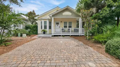 a house with a brick driveway in front of it at Luna Sea - Is a short walk to the beach and close to Seaside in Santa Rosa Beach