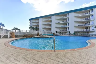 a swimming pool in front of a building at Dunes of Seagrove 301B - Updated decor with Great views and Beach service included March through October in Santa Rosa Beach