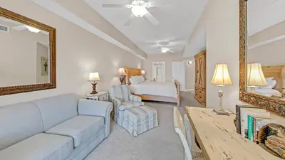 a living room with a couch and a bed and a mirror at Dunes of Seagrove 301B - Updated decor with Great views and Beach service included March through October in Santa Rosa Beach