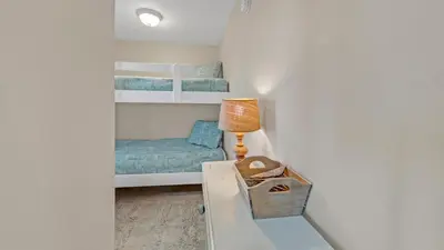 a small room with two bunk beds and a lamp at Dunes of Seagrove 301B - Updated decor with Great views and Beach service included March through October in Santa Rosa Beach