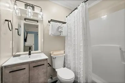 a bathroom with a toilet and a sink and a shower at Beachside Villas #312 in Santa Rosa Beach