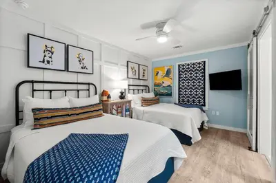 a bedroom with two beds and a tv at Beachside Villas #312 in Santa Rosa Beach