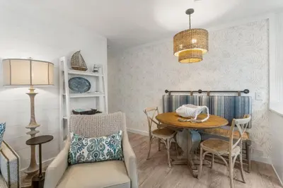 a dining room with a table and chairs at Beachside Villas #312 in Santa Rosa Beach