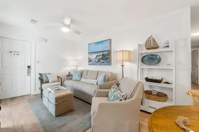 a living room with a couch and chairs and a table at Beachside Villas #312 in Santa Rosa Beach