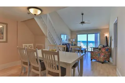 a dining room with a table and chairs at Commodore's Retreat 402 - Beach service included 2 chairs and 1 umbrella March through October in Santa Rosa Beach
