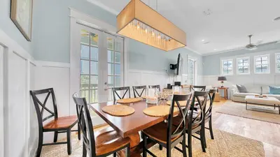 a dining room and living room with a table and chairs at Top of the Dunes - Recently Redecorated Short walk to the Beach in Santa Rosa Beach