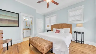 a bedroom with a white bed and a chair at Top of the Dunes - Recently Redecorated Short walk to the Beach in Santa Rosa Beach