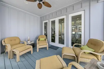 a porch with chairs and a couch and a table at Seagrove Serenity - Seagrove Beach 30a 3BD 3BA Home in Santa Rosa Beach
